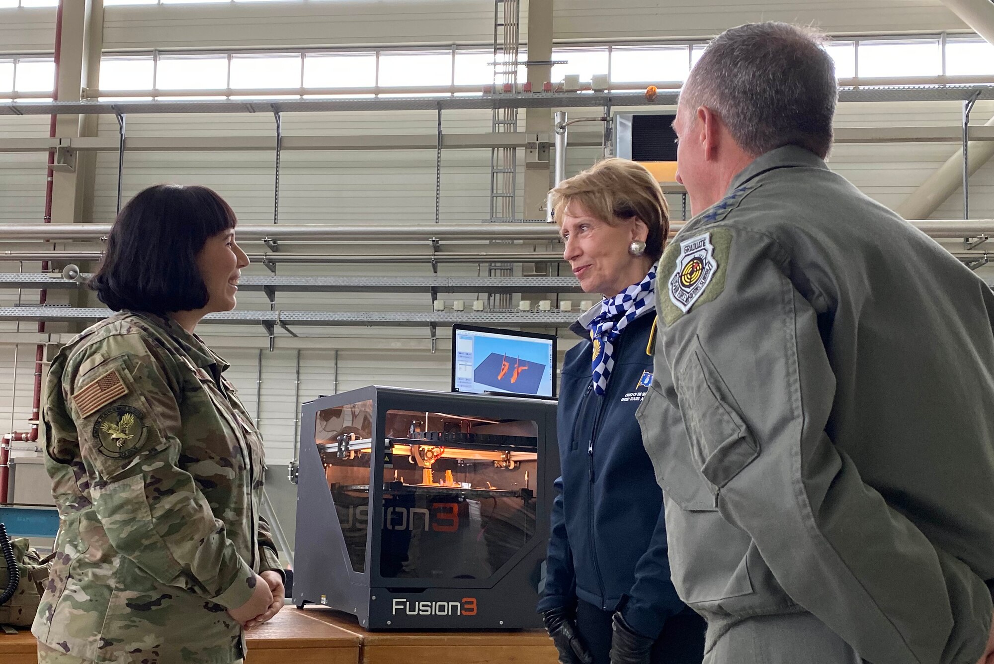 A member of the 721 Aerial Port Squadron shows Air Force Chief of Staff Gen. David L. Goldfein and Secretary of the Air Force Barbara Barrett a three dimensional printer during a tour on Ramstein Air Base, Germany, Nov. 22, 2019.