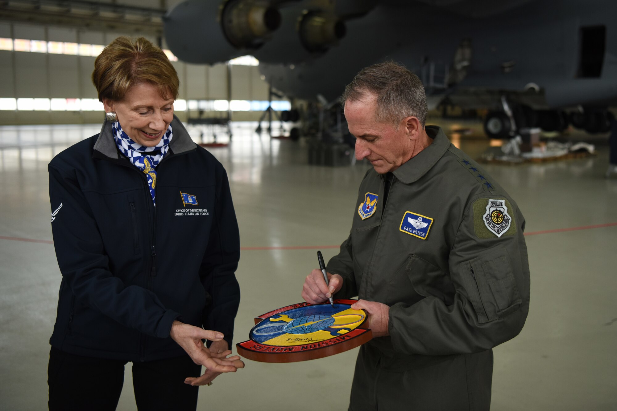 Air Force Chief of Staff Gen. David L. Goldfein and Secretary of the Air Force Barbara Barrett sign a plaque for the 721st Maintenance Squadron during a tour of Ramstein Air Base, Germany, Nov. 22, 2019.