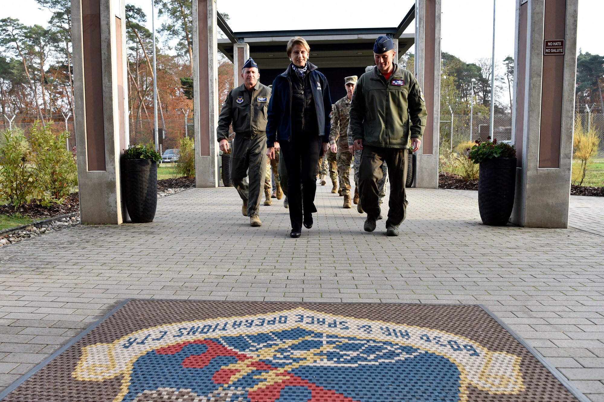 Secretary of the Air Force Barbara M. Barrett (center), U.S Air Force Chief of Staff Gen. David L. Goldfein, and Col. Cary Culbertson, 603rd Air Operations Center commander, walk towards the AOC during a base visit at Ramstein Air Base, Germany, Nov. 22, 2019.