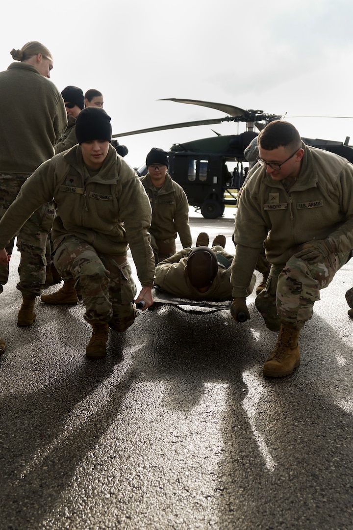 Wisconsin National Guard Soldiers practice carrying a litter during Operation Blue Moon, Nov. 2, 2019. Operation Blue Moon is a training exercise that prepared Soldiers and Airmen for deployments through firsthand training, including nine-line medevac, response to point-of-injury site, litter carries, medical care and equipment maintenance.