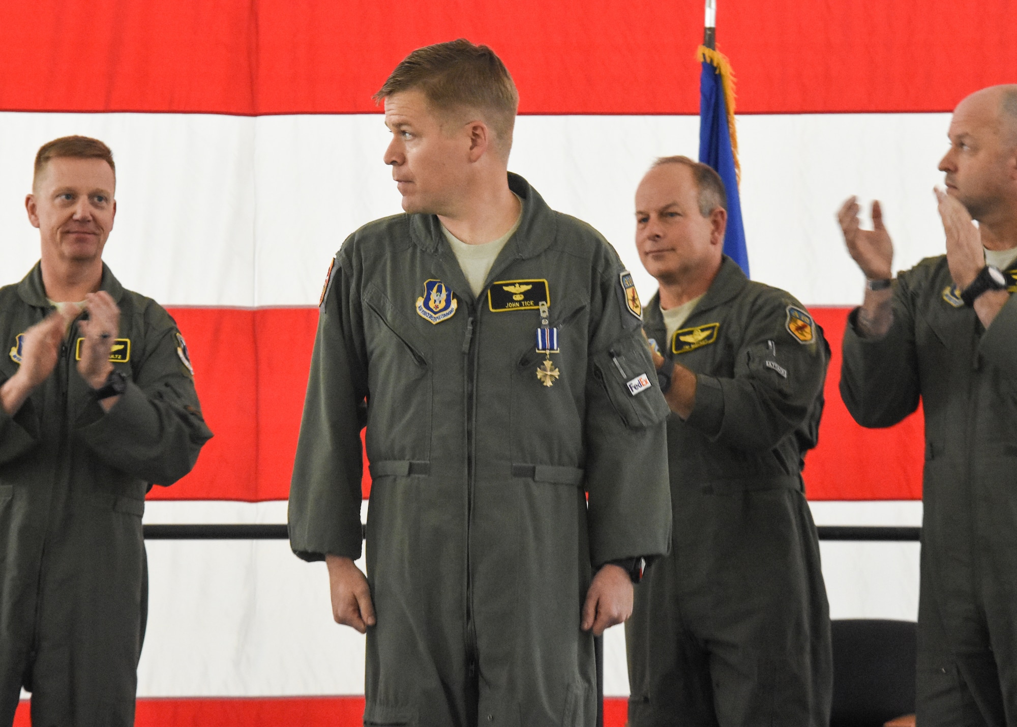 Maj. John Tice, a flight commander with the 303d Fighter Squadron, center, received the Distinguished Flying Cross and is recognized during a ceremony at Whiteman Air Force Base, Mo., Nov. 2, 2019. Tice was awarded for a mission he flew out of Kandahar Air Base, Afghanistan, in December 2010.