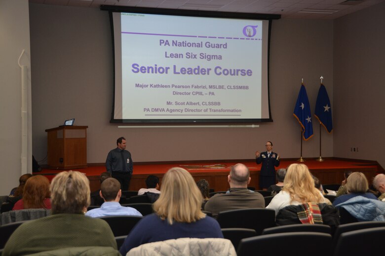 Scot Albert (left) and Maj. Katherine Fabrizi address the introduce the Lean Six Sigma Senior Leader Course to attendees on 19 November at Fort Indiantown Gap.