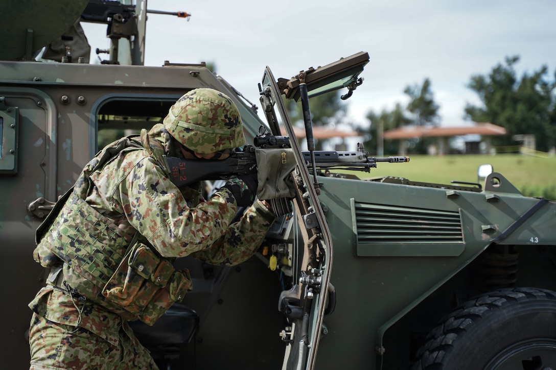 Members of the Japan Ground Self-Defense Force 15th Brigade and U.S. Marines with 4th Marine Regiment, 3rd Marine Division, conduct a simulated military operation during the JGSDF’s 15th Brigade 9th anniversary and the Camp Naha 47th anniversary on Camp Naha, Okinawa, Japan, Nov. 24, 2019. Marines from 3rd Marine Division were invited to attend the ceremony and festival of mock military operations, static displays and performances at the annual event. 3rd Marine Division continues to work alongside the JGSDF in order to increase interoperability and strengthen ties between partner nations.