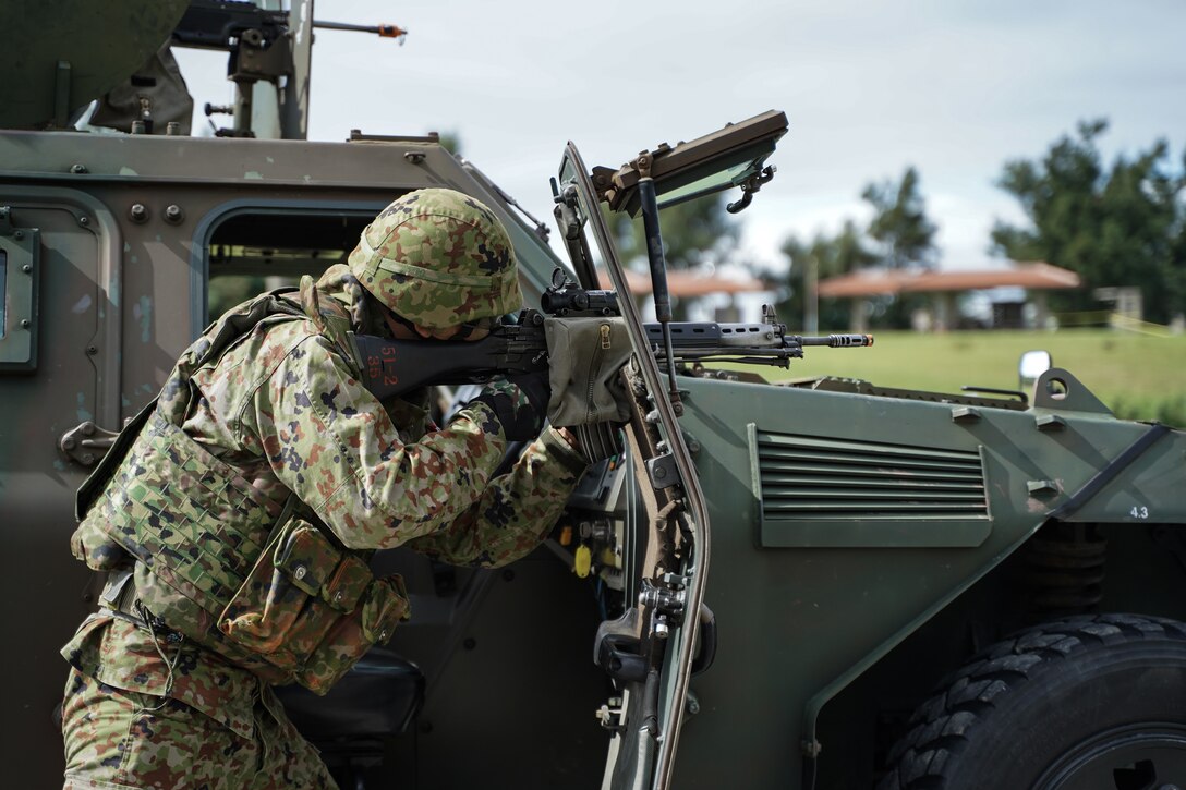 Members of the Japan Ground Self-Defense Force 15th Brigade and U.S. Marines with 4th Marine Regiment, 3rd Marine Division, conduct a simulated military operation during the JGSDF’s 15th Brigade 9th anniversary and the Camp Naha 47th anniversary on Camp Naha, Okinawa, Japan, Nov. 24, 2019. Marines from 3rd Marine Division were invited to attend the ceremony and festival of mock military operations, static displays and performances at the annual event. 3rd Marine Division continues to work alongside the JGSDF in order to increase interoperability and strengthen ties between partner nations.