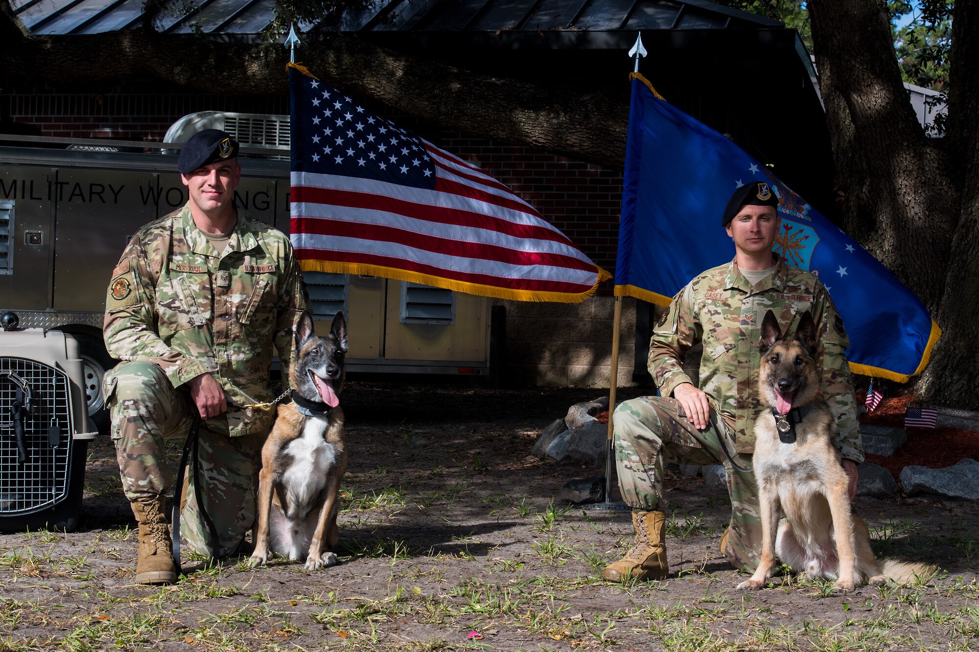 Staff Sgt. Timothy Merrigan, a military working dog handler assigned to the 628th Security Forces Squadron, his K-9 Tze, Staff Sgt. Jenings Casey, 628th SFS MWD training supervisor and his K-9 Elmo, pose after Tze and Elmo's retirement ceremony, Nov. 22, 2019 at Joint Base Charleston, S.C. Elmo served honorably for 10 years before retiring due to age and back problems while Tze's career was cut short at seven years due to back problems of his own. Both K-9s now live with their former handlers after serving their country honorably.