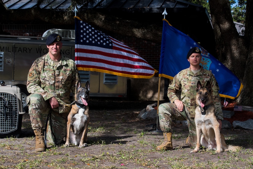 Staff Sgt. Timothy Merrigan, a military working dog handler assigned to the 628th Security Forces Squadron, his K-9 Tze, Staff Sgt. Jenings Casey, 628th SFS MWD training supervisor and his K-9 Elmo, pose after Tze and Elmo's retirement ceremony, Nov. 22, 2019 at Joint Base Charleston, S.C. Elmo served honorably for 10 years before retiring due to age and back problems while Tze's career was cut short at seven years due to back problems of his own. Both K-9s now live with their former handlers after serving their country honorably.
