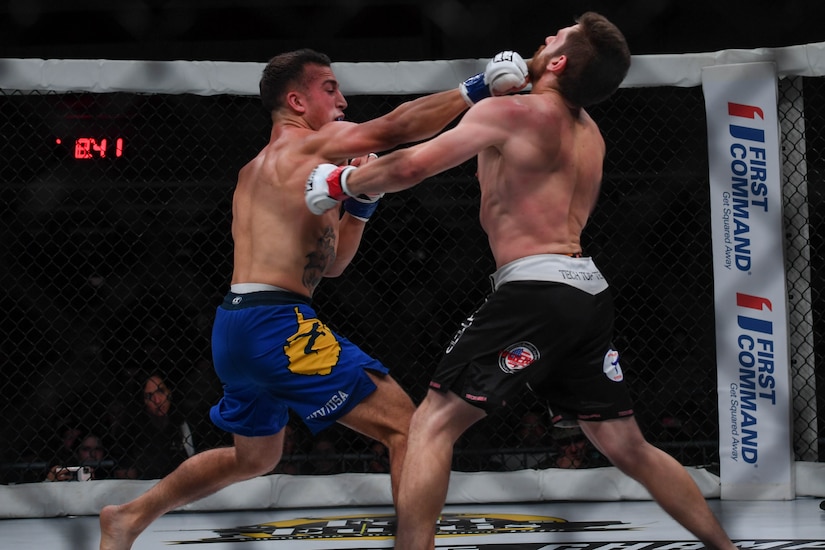 Joshua Lilley, Cage Fury Fighting Championship fighter, punches Nelson Tuckwiller, CFFC fighter during the CFFC 80 at Joint Base Langley-Eustis, Virginia, Nov. 22, 2019.