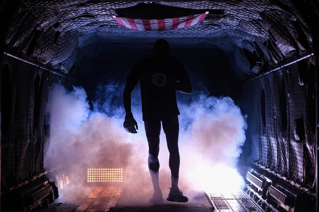 Tyus Thomas, Cage Fury Fighting Championship fighter, walks out of the back of CH-47 Chinook helicopter before a fight during CFFC 80 at Joint Base Langley-Eustis, Virginia, Nov. 22, 2019.