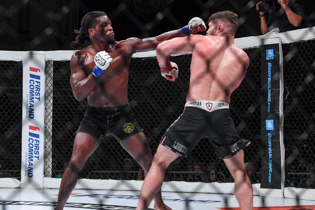 D’Juan Owens, Cage Fury Fighting Championship fighter, punches Christian Leonard, CFFC fighter, during the CFFC 80 at Joint Base Langley-Eustis, Virginia, Nov. 22, 2019.