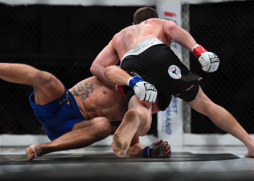 Nelson Tuckwiller, right, and Joshua Lilley, left, grapple during the Cage Fury Fighting Champion 80 “Fight for Troops” event at Joint Base Langley-Eustis, Virginia, Nov. 22, 2019.