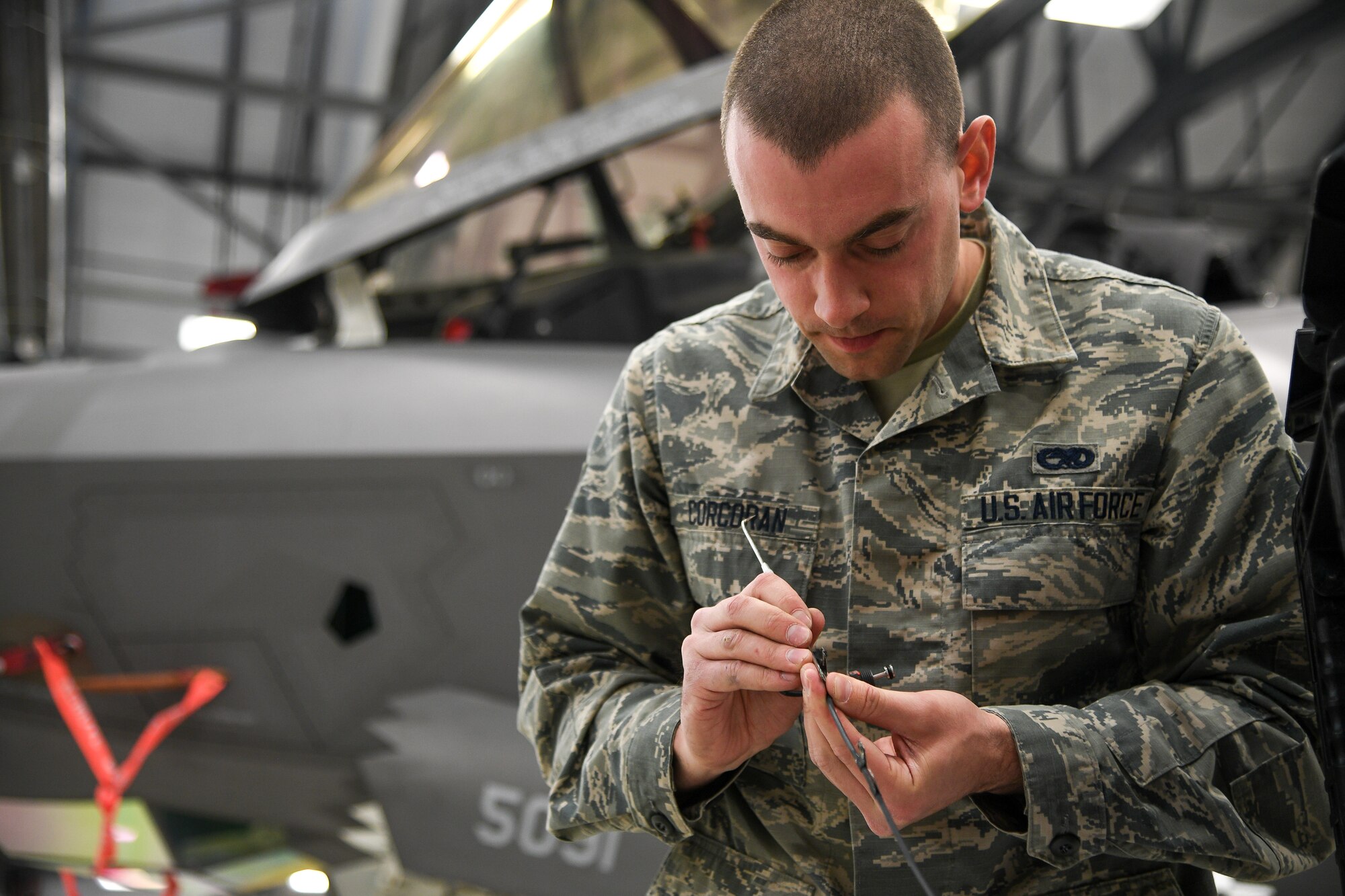 An Airman preps material for work on an F-35A canopy.