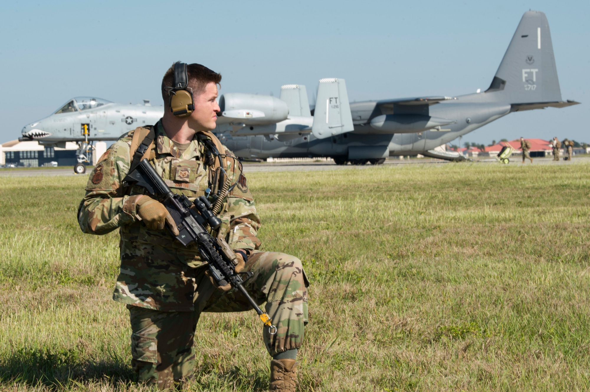 U.S. Air Force Staff Sgt. Ricky Smith, a 23rd Security Forces Squadron physical security NCO, guards a 74th Fighter Squadron A-10 Thunderbolt II and a 71st Rescue Squadron HC130J Combat King II on MacDill Air Force Base, Fla. for exercise Mobil Tiger, Nov. 19, 2019.
