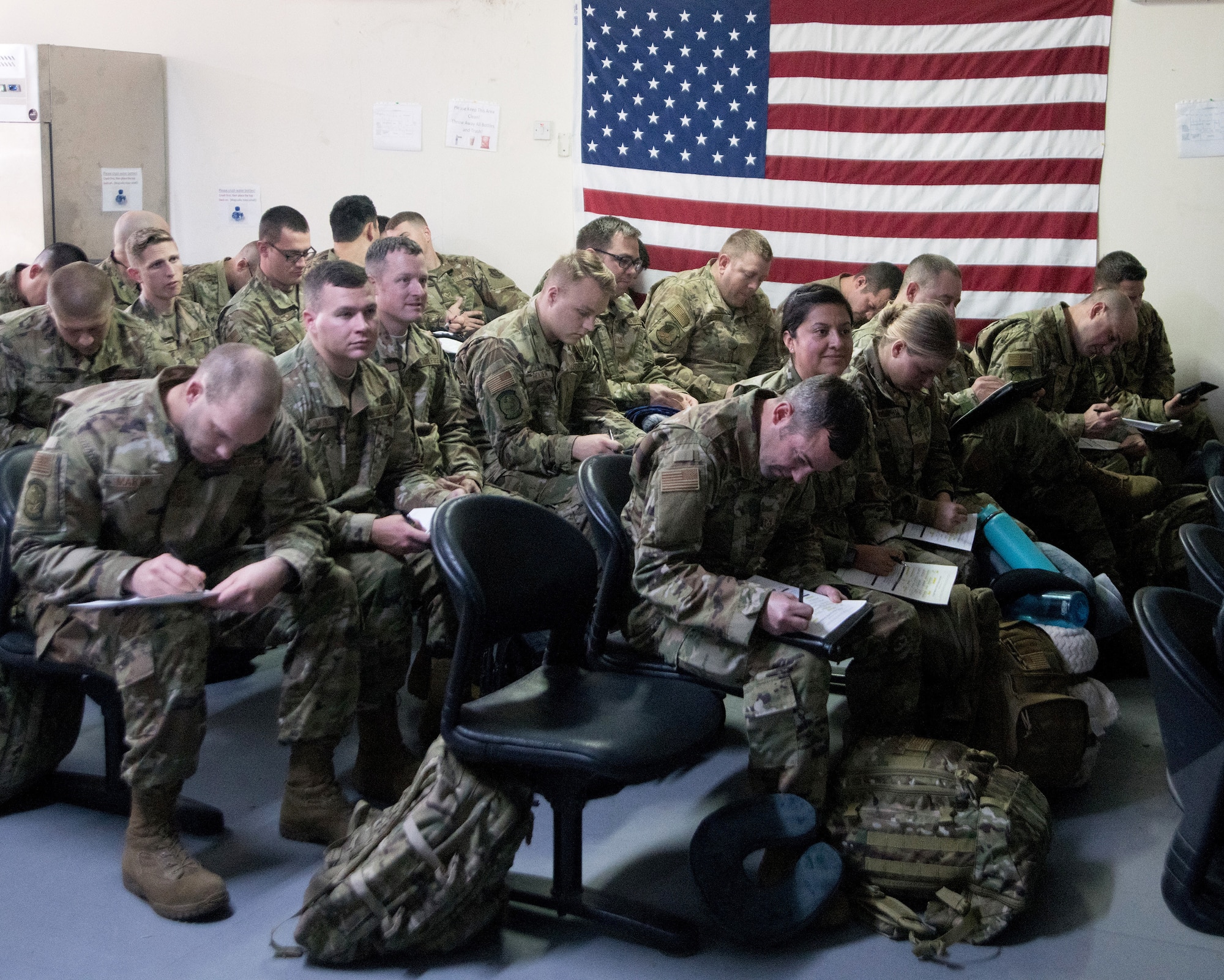 After nearly two full days of travel, reservists in the 419th Fighter Wing receive a welcome brief and complete in-processing paperwork after arriving at Al Dhafra Air Base