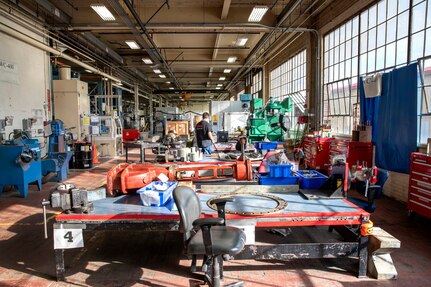 A view of Work Center-402 before Shop 31, Inside Machine Shop employees teamed with official from the Boston Consulting Group to transform the once-cluttered work space into a more productive environment.