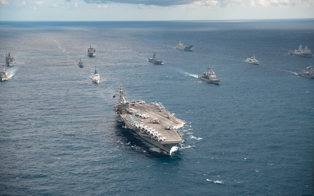 IMAGE: CORAL SEA (July 11, 2019) The U.S. Navy Nimitz-class aircraft carrier USS Ronald Reagan (CVN 76) leads a formation of 17 other ships from the U.S. Navy, U.S. Coast Guard, Royal Australian Navy, Royal Canadian Navy and Japan Maritime Self-Defense Force (JMSDF) during Talisman Sabre 2019. Talisman Sabre 2019 illustrates the closeness of the Australian and U.S. alliance and the strength of the military-to-military relationship. This is the eighth iteration of this exercise. (U.S. Navy photo by Mass Communication Specialist 3rd Class Jason Tarleton/Released)