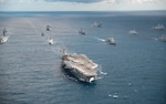 IMAGE: CORAL SEA (July 11, 2019) The U.S. Navy Nimitz-class aircraft carrier USS Ronald Reagan (CVN 76) leads a formation of 17 other ships from the U.S. Navy, U.S. Coast Guard, Royal Australian Navy, Royal Canadian Navy and Japan Maritime Self-Defense Force (JMSDF) during Talisman Sabre 2019. Talisman Sabre 2019 illustrates the closeness of the Australian and U.S. alliance and the strength of the military-to-military relationship. This is the eighth iteration of this exercise. (U.S. Navy photo by Mass Communication Specialist 3rd Class Jason Tarleton/Released)