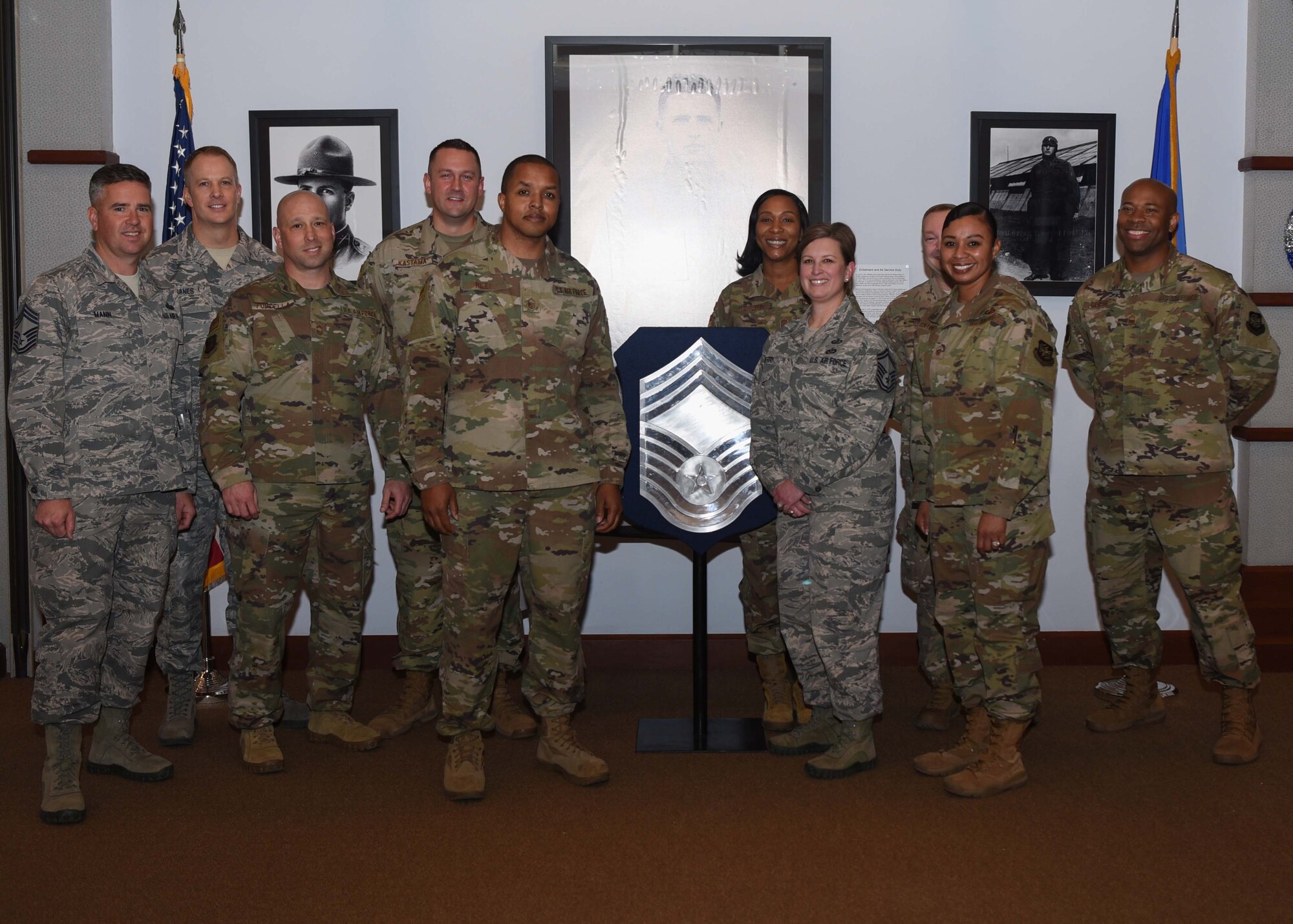 Chiefs from McConnell Air Force Base, Kan., pose with the newest Chief Master Sgt. selects Nov. 26, 2019. There were four Senior Master Sergeants chosen to promote to the rank of Chief, two of the selects were deployed. (U.S. Air Force photo by Airman 1st Class Alexi Bosarge)