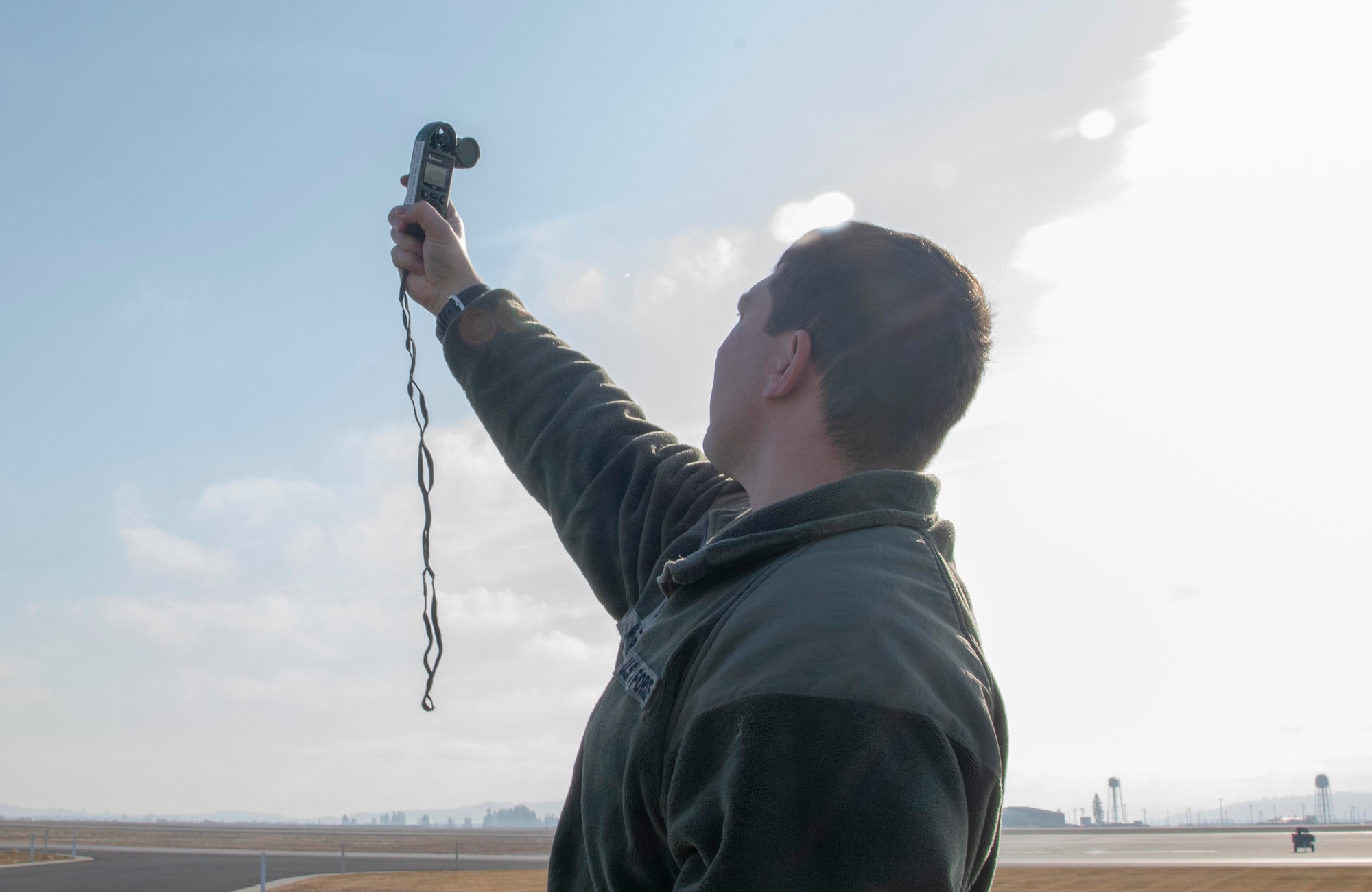 U.S. Air Force Tech Sgt. Johnny McGuire, 92nd Operational Support Squadron weather forecaster, uses a Kestrel device to gather an hourly record of weather data at Fairchild Air Force Base, Washington, Nov. 14, 2019.