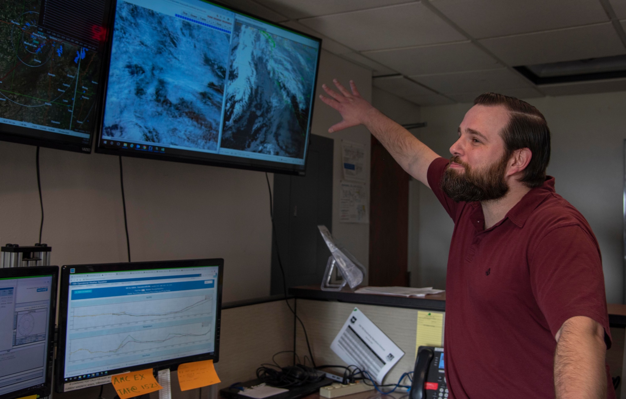 Jacob Marche, 92nd Operational Support Squadron weather technician, explains the current cloud cover shown on the satellite and Doppler radar at Fairchild Air Force Base, Washington, Nov. 14, 2019.