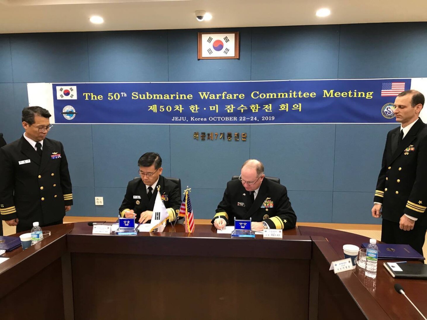 Rear Adm. Jimmy Pitts, Commander, Submarine Group 7, right, signs a memorandum with Rear Adm. Jung Il Shik, Commander, ROK Navy Submarine Force at the conclusion of the 50th semiannual Submarine Warfare Committee Meeting (SWCM) in Jeju, South Korea. Over the past 25 years, leaders of both the U.S. and ROK submarine forces have met consistently in recognition of the importance of combined submarine training and force integration. (U.S. Navy photo by LT Gregory Pavone)