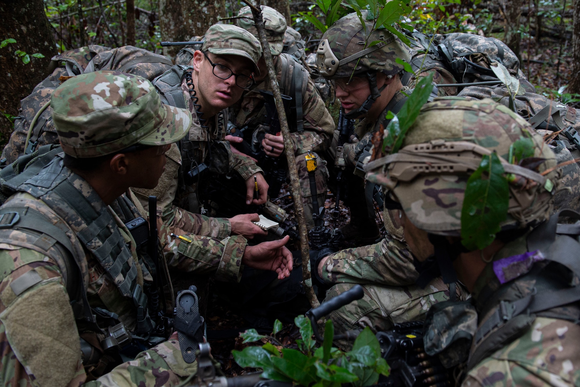 Squad leaders discuss strategy during an Air Force Ranger Assessment Course Nov. 15, 2019, at Moody Air Force Base, Ga. The course teaches students critical tasks such as land navigation, troop movements and shooting and maintaining weapons. Over the course of 19 days, the Ranger Assessment Course evaluates students determine if they possess the knowledge, willpower and skill to attend Army Ranger School. (U.S. Air Force photo by Airman Azaria E. Foster)