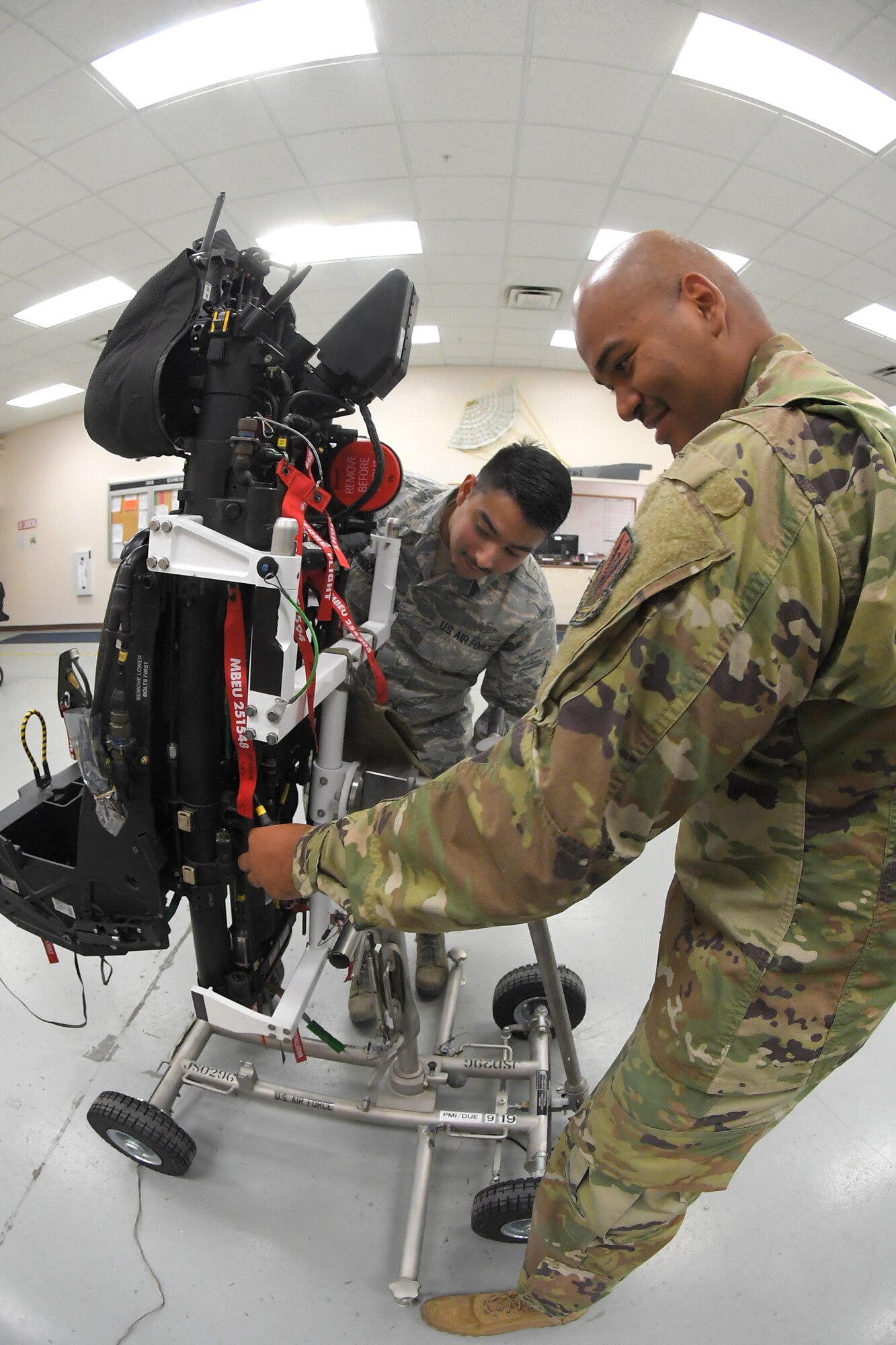 A photo of Airmen servicing F-35A ejection seat