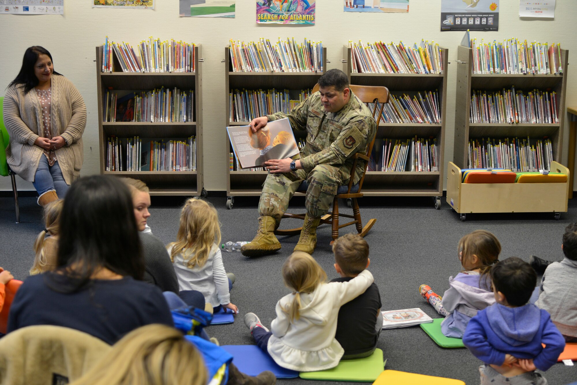 U.S. Air Force Chief Master Sgt. Ernesto J. Rendon, 86th Airlift Wing command chief, reads to children during Story Time at Ramstein Library, Ramstein Air Base, Nov. 21, 2019. Throughout December, each Story Time will celebrate a different holiday of the season. (U.S. Air Force photo by Airman 1st Class John R. Wright)