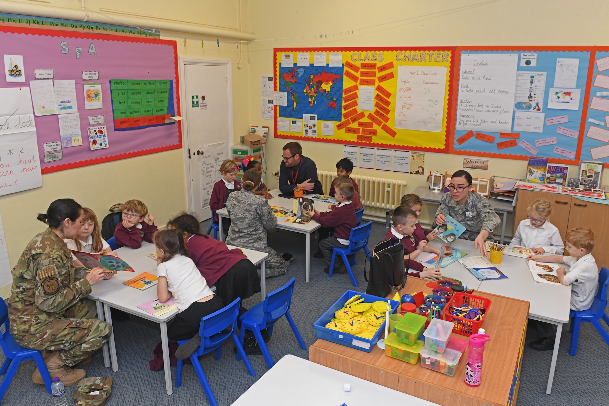 Airmen from the 100th Air Refueling Wing read to children at Houldsworth Valley Primary School in Newmarket, England, Nov. 26, 2019. The purpose of the event was to build relations with the community while also focusing on the importance of reading for the students. (U.S. Air Force photo by Senior Airman Luke Milano)