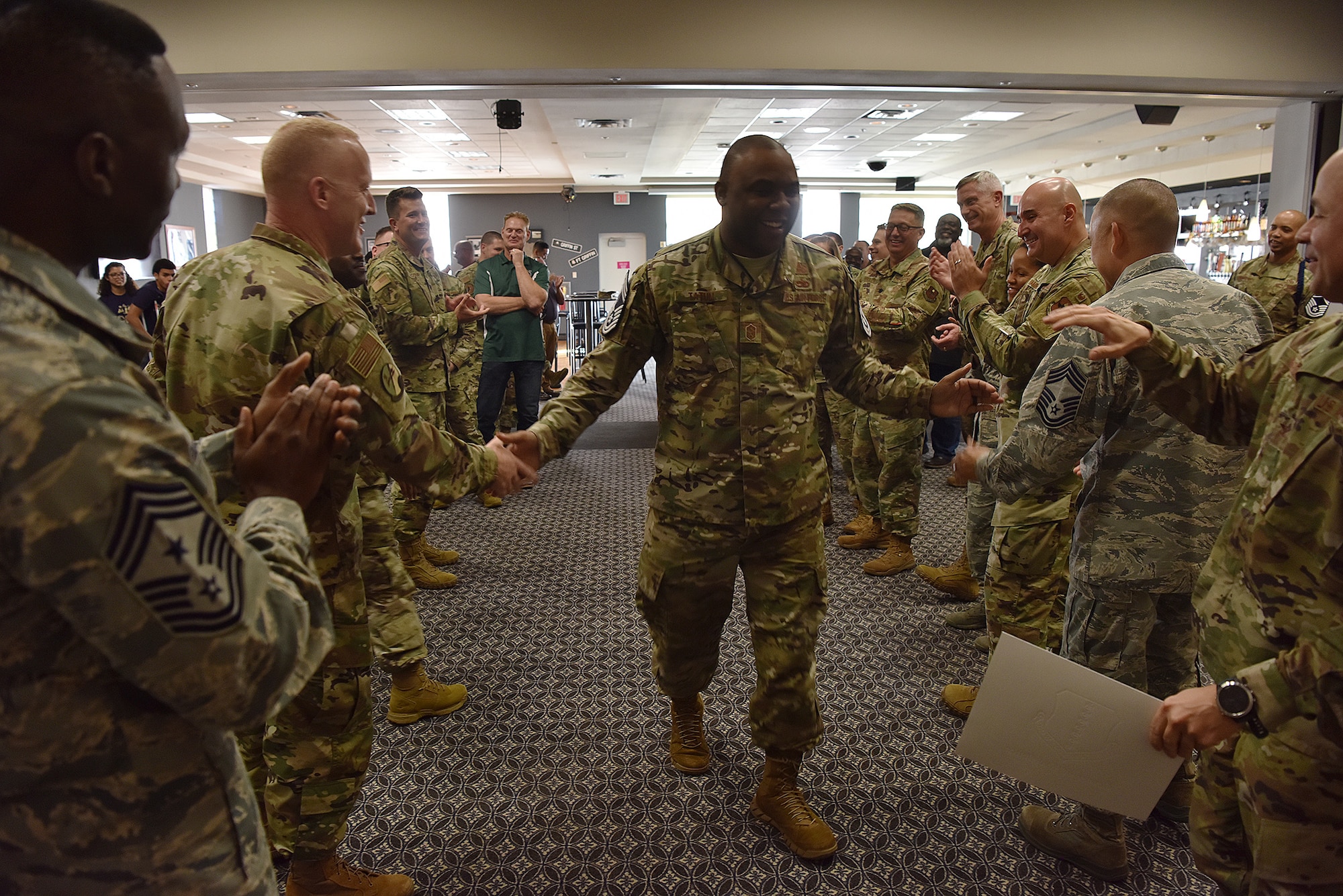 Team Goodfellow members congratulate Senior Master Sgt. Charmane Tatum on his promotion selection during the Chief Master Sergeant Release Ceremony at the Event Center on Goodfellow Air Force Base, Texas, Nov. 26, 2019. The rank of chief master sergeant is reserved for the top one percent of U.S. Air Force enlisted members. (U.S. Air Force photo by Staff Sgt. Chad Warren/released)