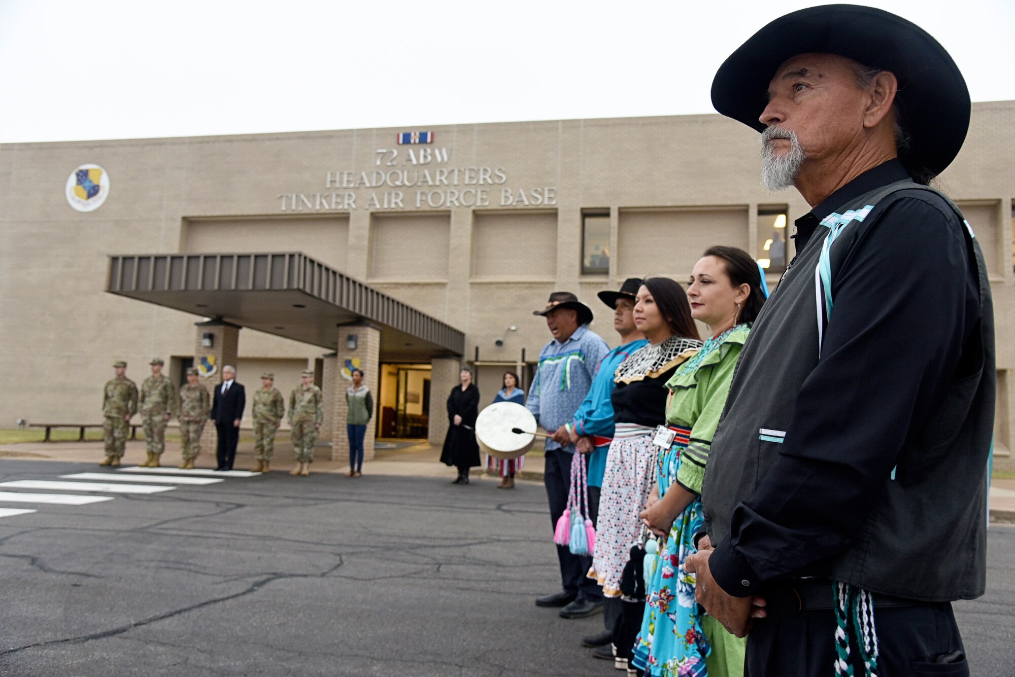An image of the Tinker Inter-Tribal Council and members and dancers from the Chickasaw Nation Honor Guard after a flag retreat ceremony