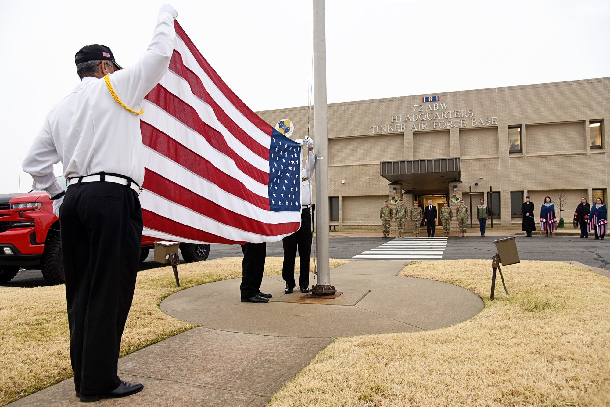 An image of the Tinker Inter-Tribal Council and members and dancers from the Chickasaw Nation Honor Guard after a flag retreat ceremony