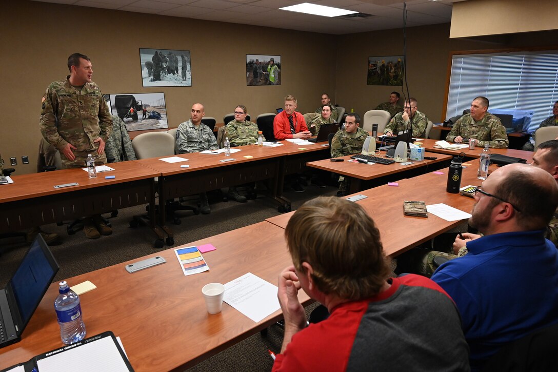 Sgt. 1st Class Charles Highland, left, stands to contribute during a TAG employee advisory board meeting at the North Dakota Air National Guard Base, Fargo, N.D., Nov. 15, 2019.
