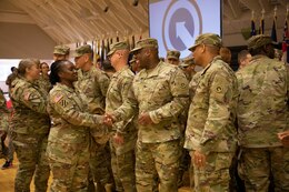 Sgt. Maj. Gail Lashley, senior logistician, G-4, 1st Theater Sustainment Command (TSC), shakes hands with Sgt. 1st Class William Bell, maintenance management NCO, Support Operations (SPO), Operational Contracting Support, 1st TSC, at a deployment ceremony at Sadowski Center on Fort Knox, Ky. Bell will be deploying with the Strategic Operations and Plans (SOaP) "Blue Team" to the U.S. Central Command (CENTCOM) area of operations.