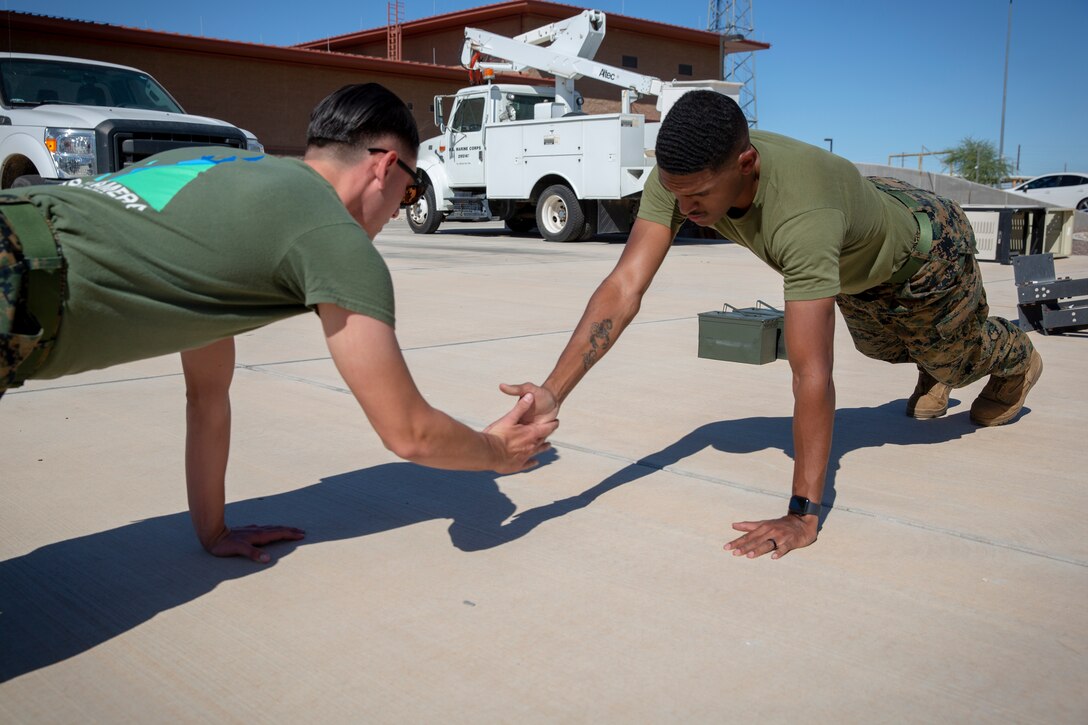 U.S. Marines with Station Communications Strategy and Operations, Marine Corps Air Station (MCAS) Yuma, engage in a physical fitness workout in order to prepare themselves for the combat fitness test (CFT) on MCAS Yuma, Oct. 22, 2019. A CFT is composed of an 880-yard sprint, ammo can presses for two minutes, and performing a times event, the maneuver-under-fire, in which Marines conduct combat related tasks. (U.S. Marine Corps photo by Lance Cpl. Andres Hernandez)