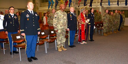 Joint Base San Antonio-Fort Sam Houston leadership and attendees stand for the Armed Services medley at the conclusion of the National American Indian Heritage Month celebration, hosted by Regional Health Command-Central Nov. 19.