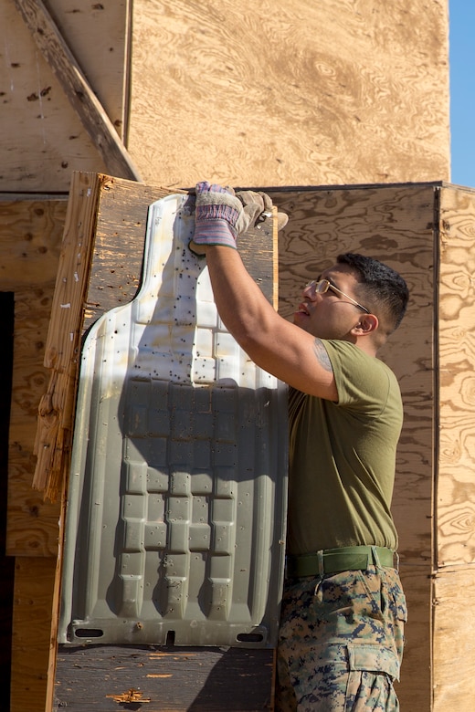 U.S. Marine Corps Pfc. Myron W. Robinson, military police with Marine Corps Air Station (MCAS) Yuma, helps remove an old structure as part of a cleanup effort Oct. 22, 2019 on the Barry M. Goldwater Range (BMGR) West. The BMGR consists of about 1.7 million acres of land and MCAS Yuma manages over 650,000 of those acres. (U.S. Marine Corps photo by Cpl. Nicole Rogge)