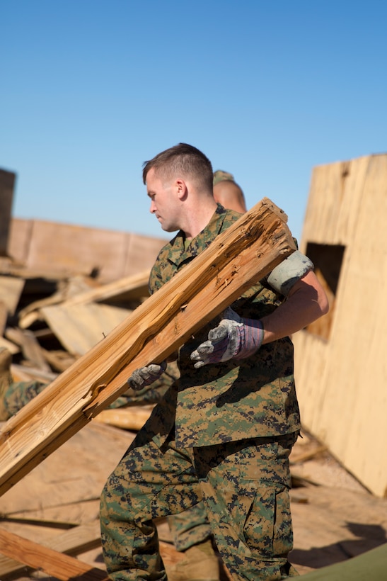 U.S. Marine Corps Pfc. Myron W. Robinson, military police with Marine Corps Air Station (MCAS) Yuma, helps remove an old structure as part of a cleanup effort Oct. 22, 2019 on the Barry M. Goldwater Range (BMGR) West. The BMGR consists of about 1.7 million acres of land and MCAS Yuma manages over 650,000 of those acres. (U.S. Marine Corps photo by Cpl. Nicole Rogge)