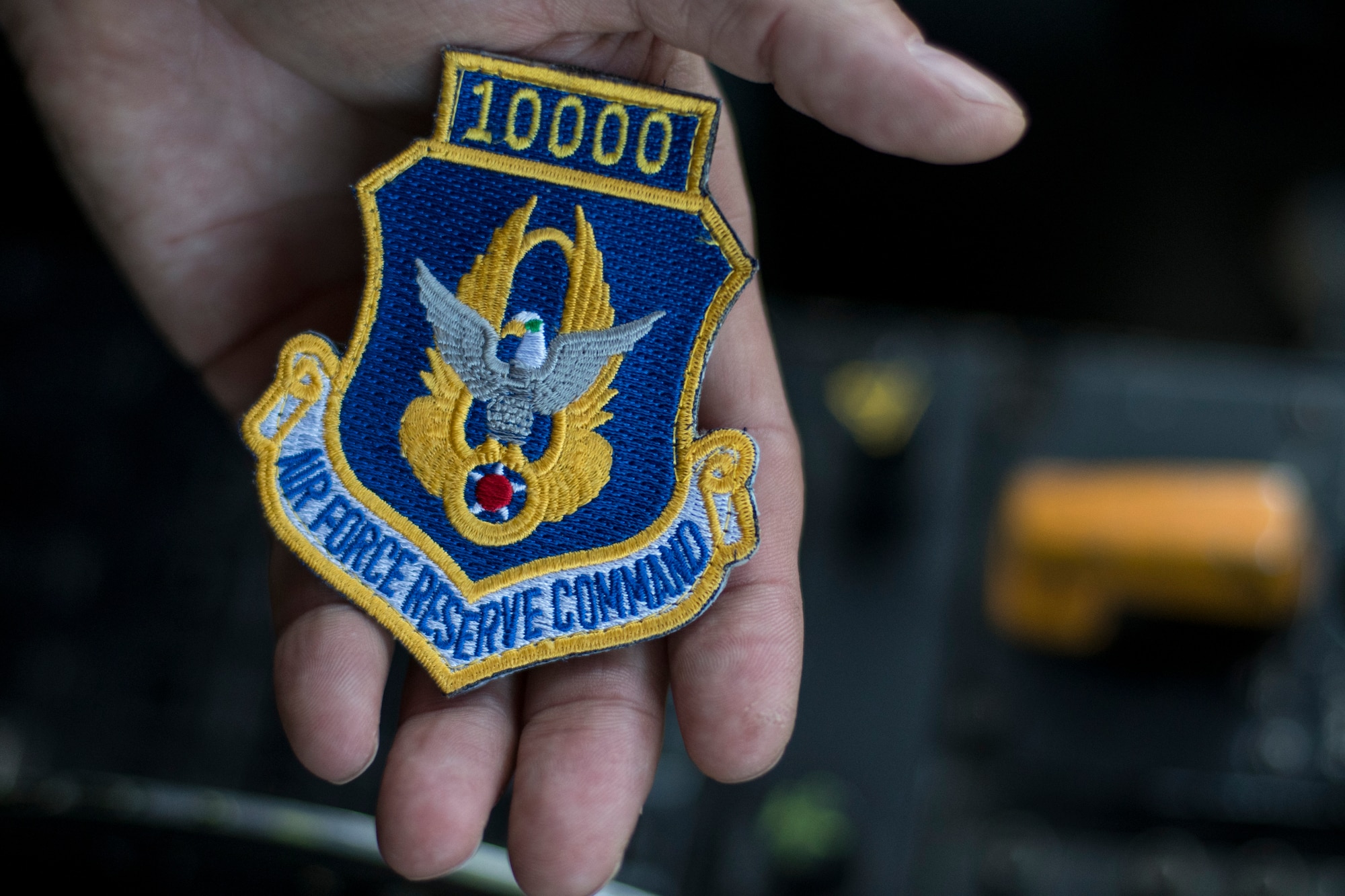 Chief Master Sgt. Terry Studstill, 700th Airlift Squadron flight engineer superintendent, shows a patch displaying 10,000 hours shortly before taking off on a flight from Dobbins Air Reserve Base, Ga. on Nov. 25, 2019. During the flight, he reached 10,000 hours, a major milestone in an aviator's career. (U.S. Air Force photo/Tech. Sgt. Andrew Park)