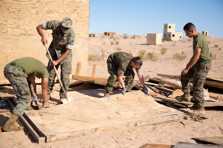 U.S. Marine Corps Pfc. Myron W. Robinson, military police with Marine Corps Air Station (MCAS) Yuma, helps remove an old structure as part of a cleanup effort Oct. 22, 2019 on the Barry M. Goldwater Range (BMGR) West. The BMGR consists of about 1.7 million acres of land and MCAS Yuma manages over 650,000 of those acres. (U.S. Marine Corps photo by Cpl. Nicole Rogge)