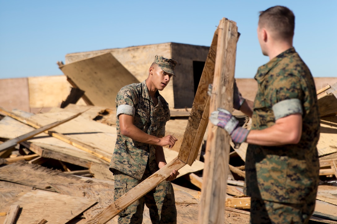 U.S. Marine Corps Pfc. Myron W. Robinson, military police with Marine Corps Air Station (MCAS) Yuma, helps remove an old structure as part of a cleanup effort Oct. 22, 2019 on the Barry M. Goldwater Range (BMGR) West. The BMGR consists of about 1.7 million acres of land and MCAS Yuma manages over 650,000 of those acres. (U.S. Marine Corps photo by Cpl. Nicole Rogge)