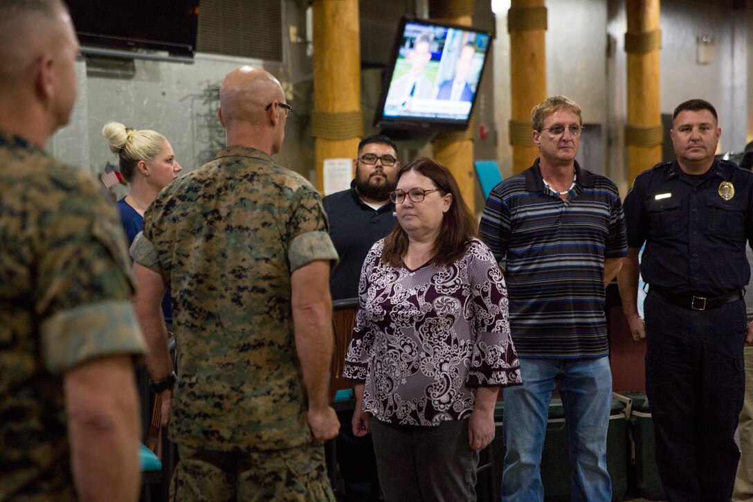 U.S. Marine Corps Col. David A. Suggs and Sgt. Maj. David M. Leikwood, the Commanding Officer and Sergeant Major of Marine Corps Air Station (MCAS) Yuma, present the Employee of the Year (EOY) Award to Ms. Sherri Utley, Oct. 24, 2019. Utley, previously selected as MCAS Yuma Employee of the Quarter, demonstrated she is the employee who shows the most work ethic, dedication, and the highest commitment throughout the entire year. (U.S. Marine Corps photo by Cpl Nicole Rogge)