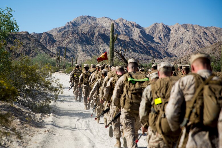 U.S. Marine Corps Lt.Col. James C. Paxton, the commanding officer of Marine Corps Air Station (MCAS) Yuma's Headquarters & Headquarters Squadron, leads non-commissioned officers (NCOs) in a hike during “Operation Backbone" in Yuma, Arizona, Oct. 25, 2019. Operation Backbone helps to strengthen the warrior spirit in NCOs and promote cohesion between the different units of MCAS Yuma. The exercise consisted of a five and a half mile hike, several classes, and closed with a warriors night dinner. Classes included simulated room clearing, a Search and Rescue (SAR) demonstration, and proper procedure when fitting a tourniquet. (U.S. Marine Corps photo by Cpl. Nicole Rogge)