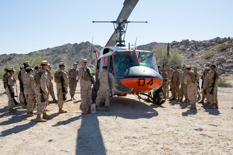 U.S. Marine Corps Lt.Col. James C. Paxton, the commanding officer of Marine Corps Air Station (MCAS) Yuma's Headquarters & Headquarters Squadron, leads non-commissioned officers (NCOs) in a hike during “Operation Backbone" in Yuma, Arizona, Oct. 25, 2019. Operation Backbone helps to strengthen the warrior spirit in NCOs and promote cohesion between the different units of MCAS Yuma. The exercise consisted of a five and a half mile hike, several classes, and closed with a warriors night dinner. Classes included simulated room clearing, a Search and Rescue (SAR) demonstration, and proper procedure when fitting a tourniquet. (U.S. Marine Corps photo by Cpl. Nicole Rogge)