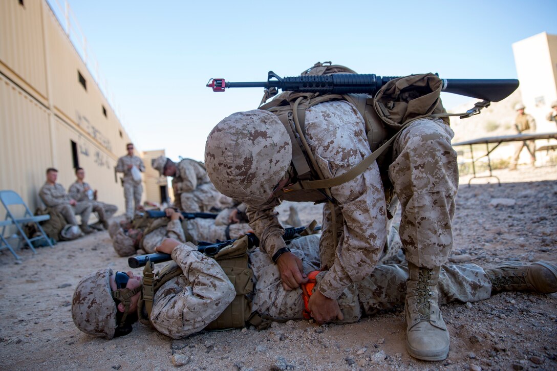 U.S. Marine Corps Lt.Col. James C. Paxton, the commanding officer of Marine Corps Air Station (MCAS) Yuma's Headquarters & Headquarters Squadron, leads non-commissioned officers (NCOs) in a hike during “Operation Backbone" in Yuma, Arizona, Oct. 25, 2019. Operation Backbone helps to strengthen the warrior spirit in NCOs and promote cohesion between the different units of MCAS Yuma. The exercise consisted of a five and a half mile hike, several classes, and closed with a warriors night dinner. Classes included simulated room clearing, a Search and Rescue (SAR) demonstration, and proper procedure when fitting a tourniquet. (U.S. Marine Corps photo by Cpl. Nicole Rogge)