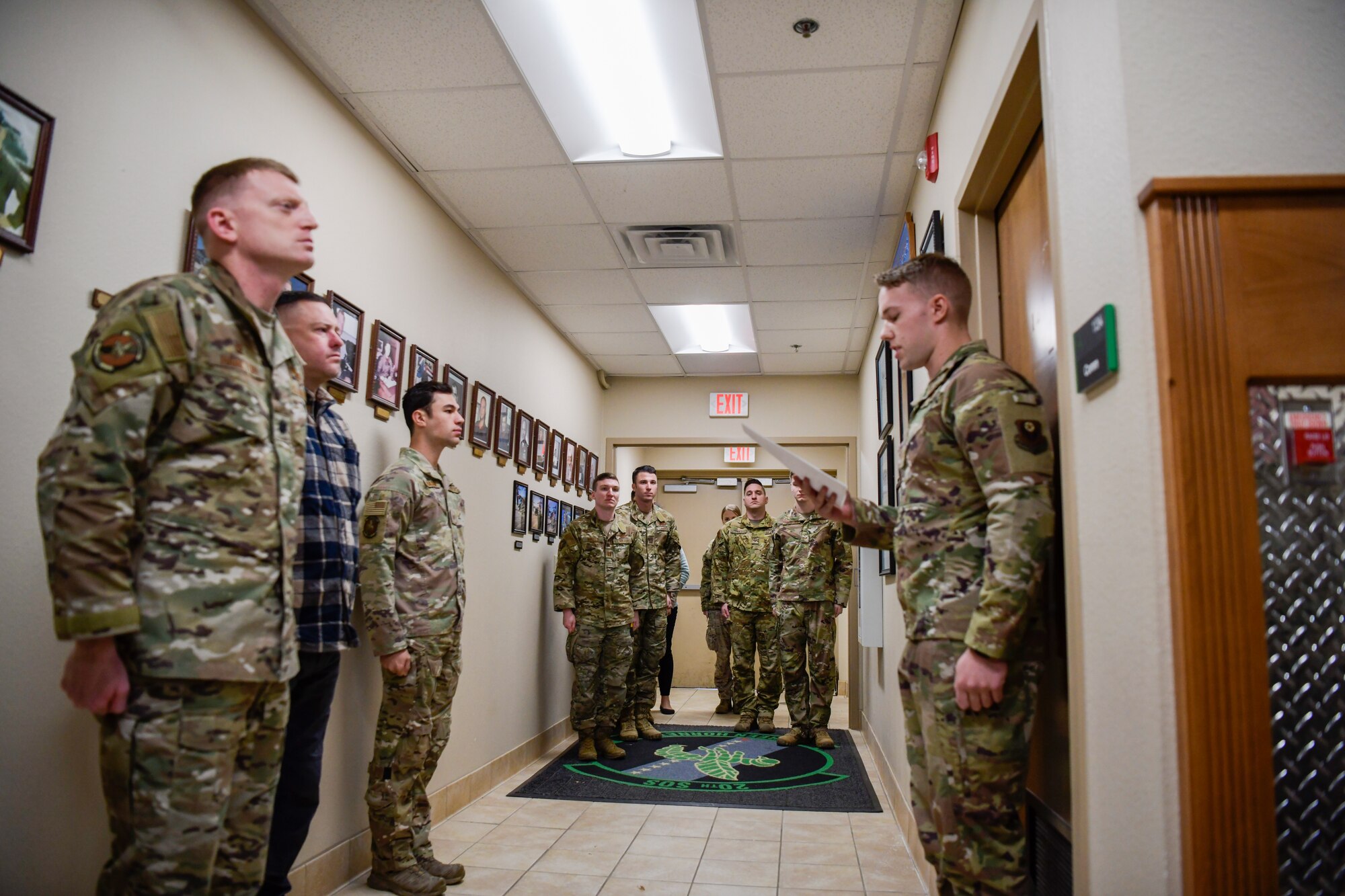 Members of the 20th Special Operations Squadron stand at attention at their squadron building for a ceremony on Cannon Air Force Base, N.M., Nov. 26, 2019. The ceremony was held to honor a Medal of Honor recipient and Vietnam War veteran, Col. James Fleming of the 20th SOS. (U.S. Air Force photo by Senior Airman Marcel Williams)