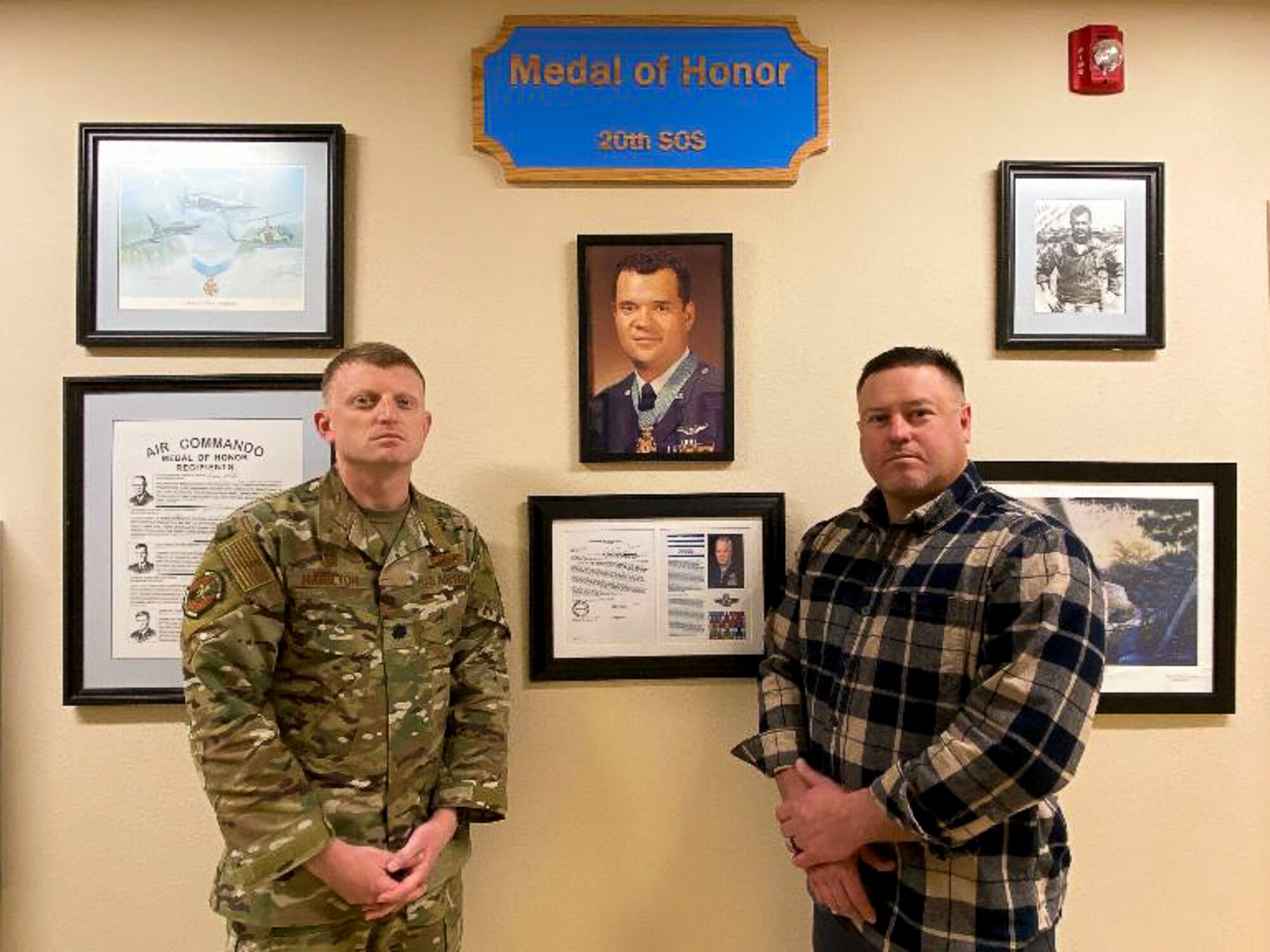 Lt. Col. Hamilton, 20th Special Operations Squadron commander, left, and Ret. Marine Glenn Russ, gather at the 20th SOS building for a ceremony on Cannon Air Force Base, N.M., Nov. 26, 2019. Russ has served for 21 years in the local community on the Curry County police force and was contacted directly to design an addition to the wall. (U.S. Air Force photo by Senior Airman Marcel Williams)