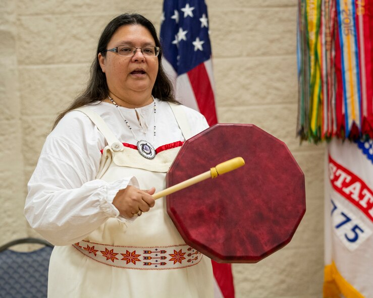 Guest speaker Kim Sigafus McIver sings and beats drum during observance