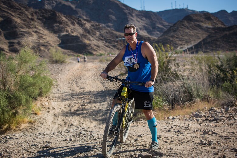 Competitors in the 2nd Annual Telegraph Pass Challenge prepare to start the 5 mile bike portion of the race in Yuma, Ariz., Nov. 2, 2019. The challenge, coordinated by Marine Corps Community Services (MCCS), offered participants the opportunity to compete for first, second, or third place in either a 5 mile run, 5 mile bike route, or both. (U.S. Marine Corps photo by Sgt. Isaac D. Martinez)