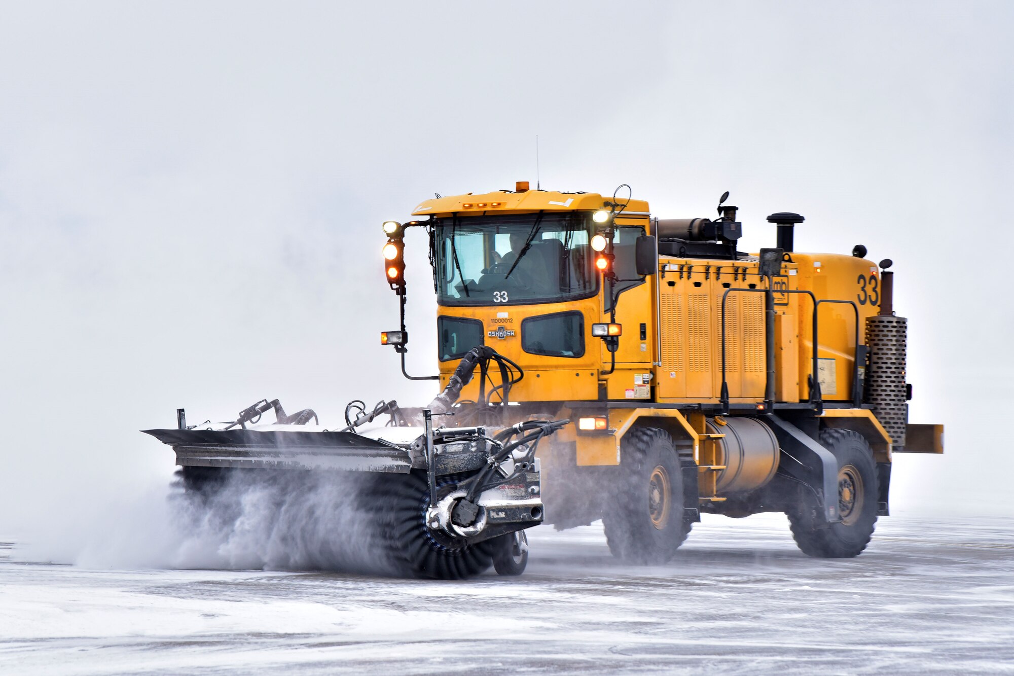 A 354th Civil Engineer Squadron pavements and construction equipment operator clears snow from the flight line at Eielson Air Force Base, Alaska, Nov. 26, 2019. To completely clear one inch of snow off of the runway, 354 CES Airmen have to move approximately 495,000 pounds of snow. (U.S. Air Force photo by Senior Airman Beaux Hebert)