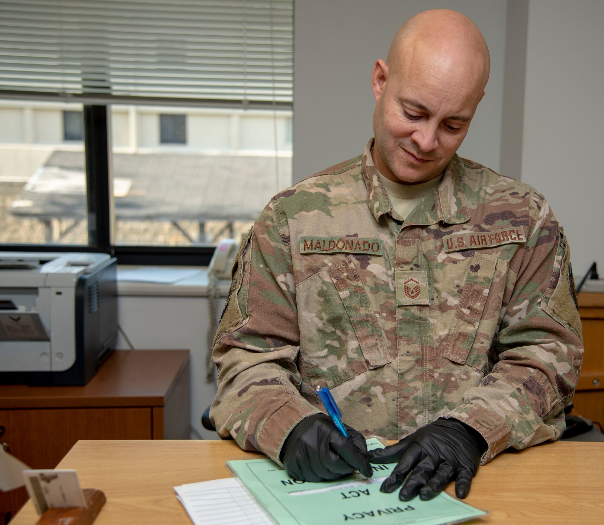 Master Sgt. Jason Maldonado, 436th Air Wing Drug Demand Reduction Program collector, signs an Airman in for testing November 8, 2019. All U.S. service members are subject to random urinalysis testing. (U.S. Air Force photo by Staff Sgt. Nicole Leidholm)